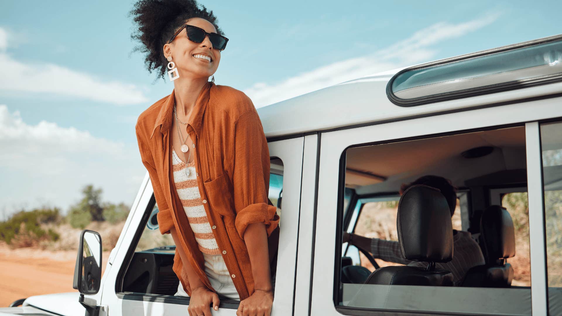 woman smiling outside of van