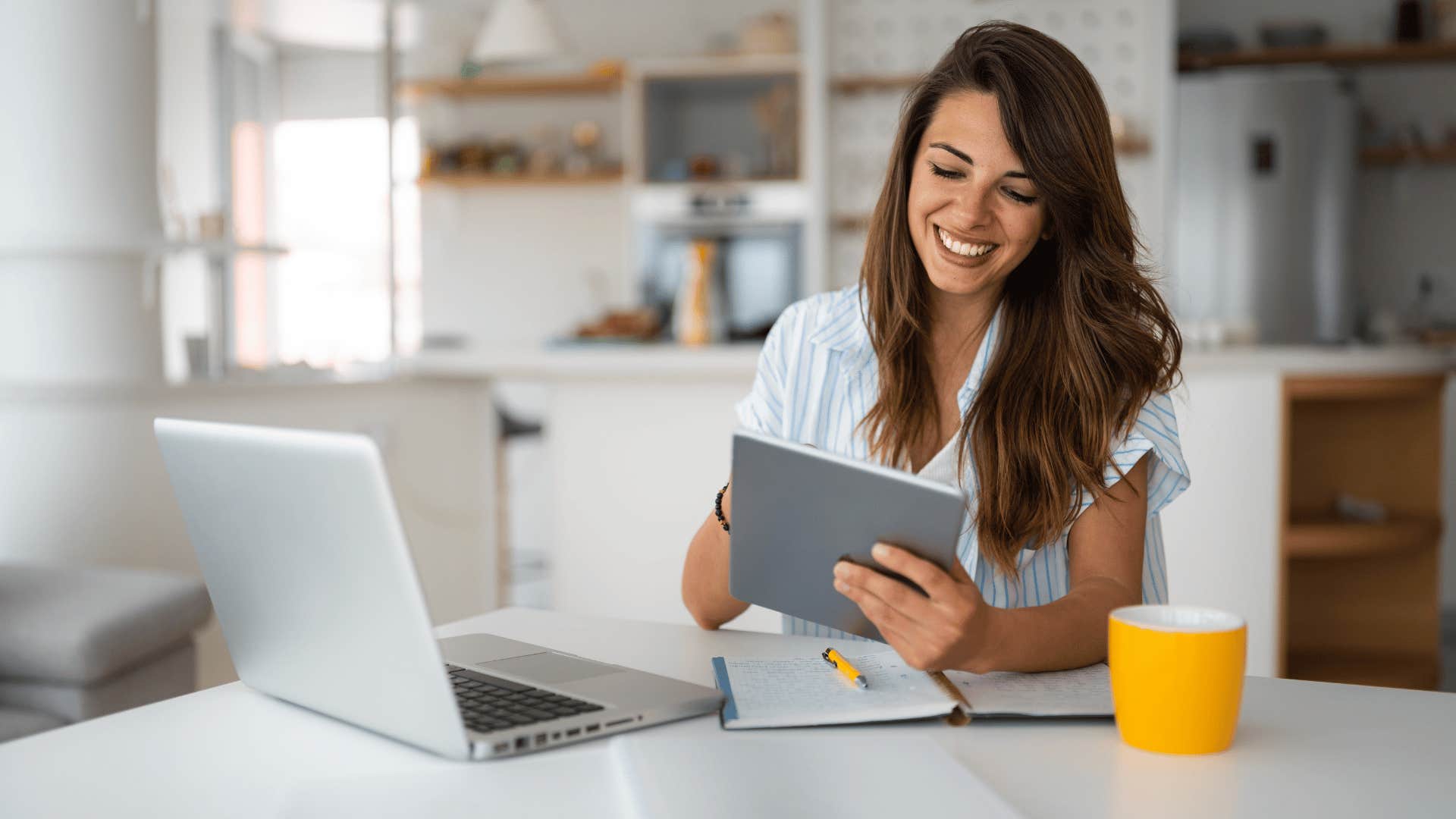 woman smiling and working on laptop