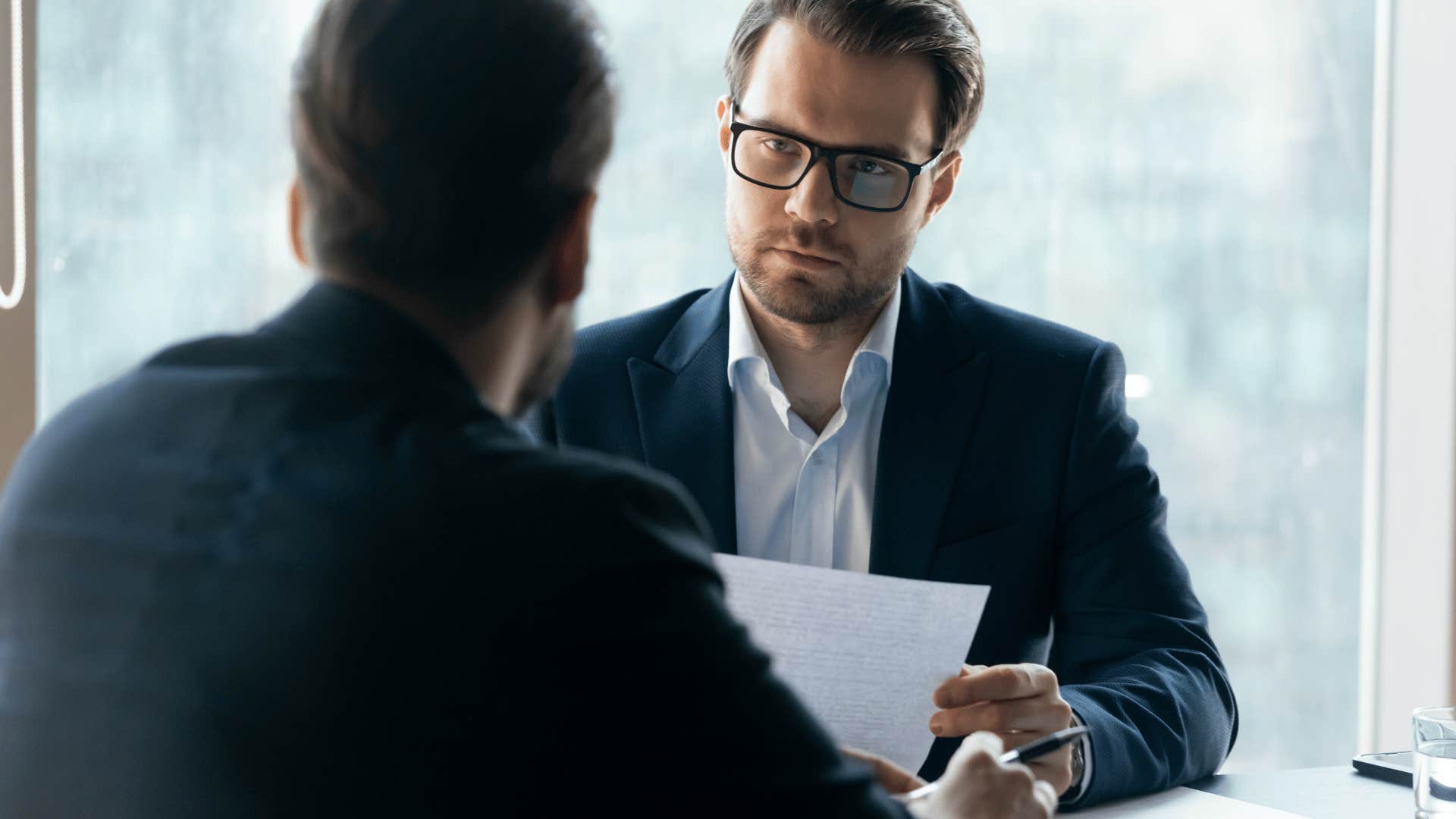 strict man giving interview