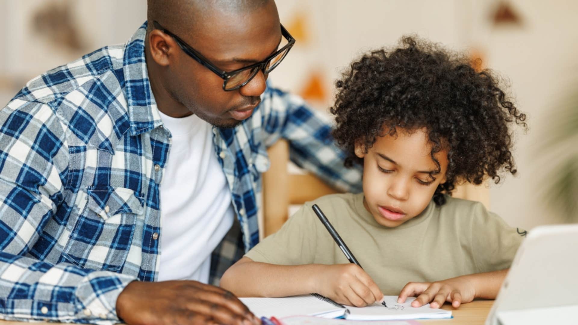dad helping young son with his homework