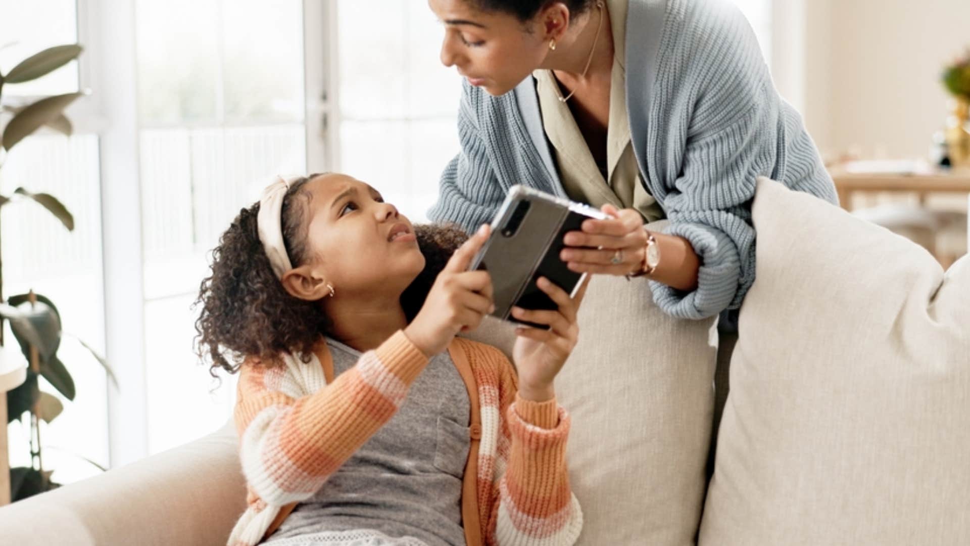 mom enforcing screen time with daughter
