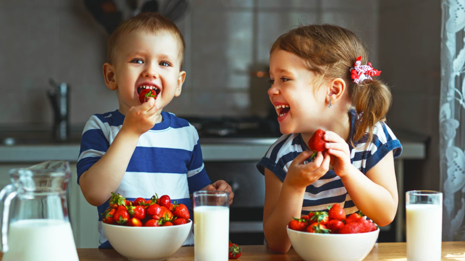 kids eating strawberries as a snack