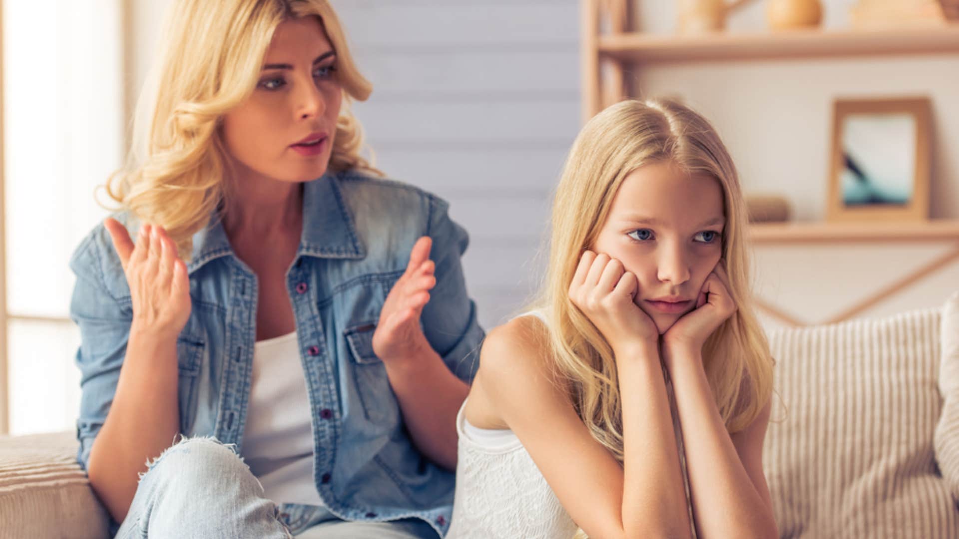 girl being silent as mom scolds her for talking back