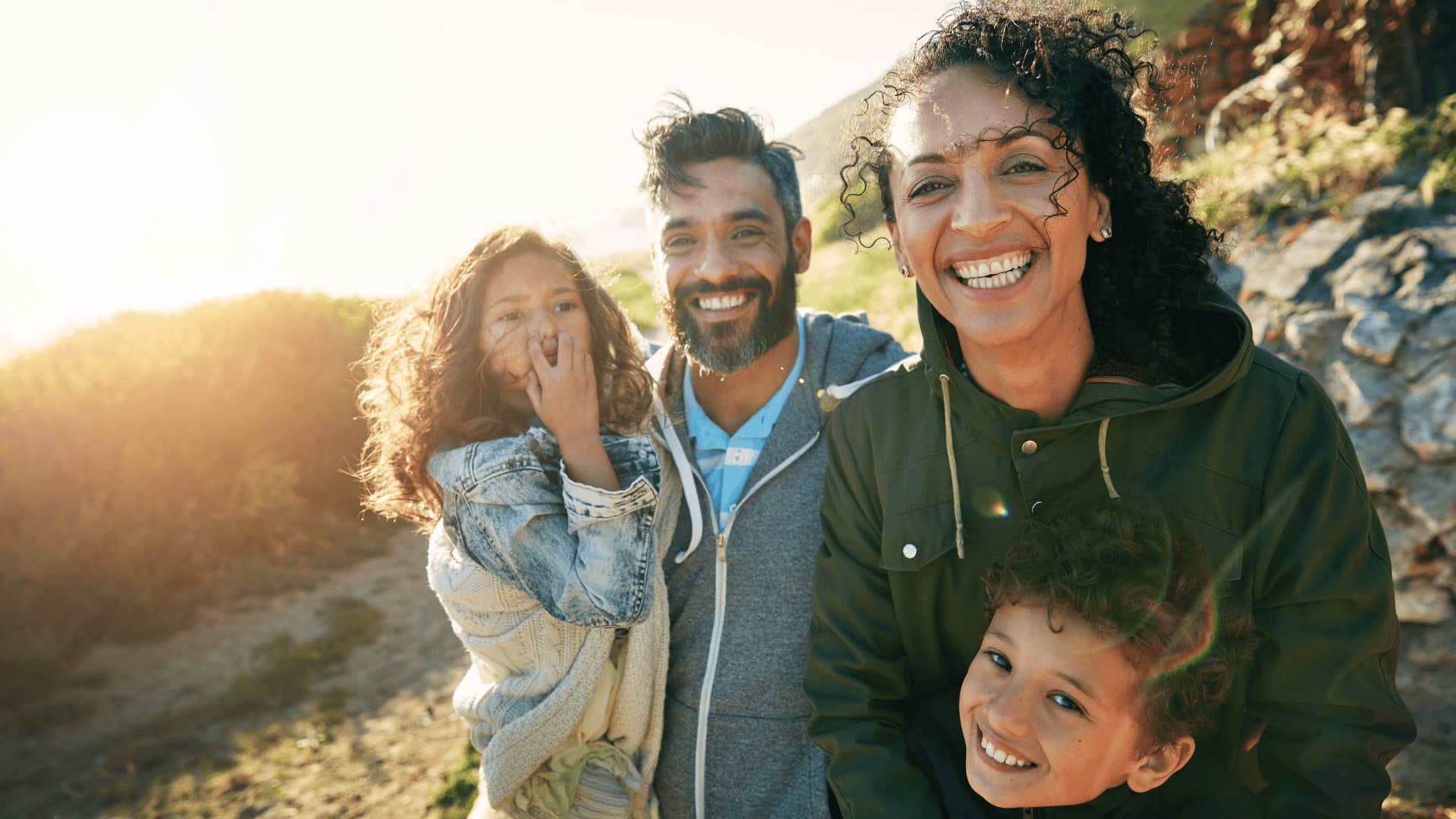 family smiling on a hike together