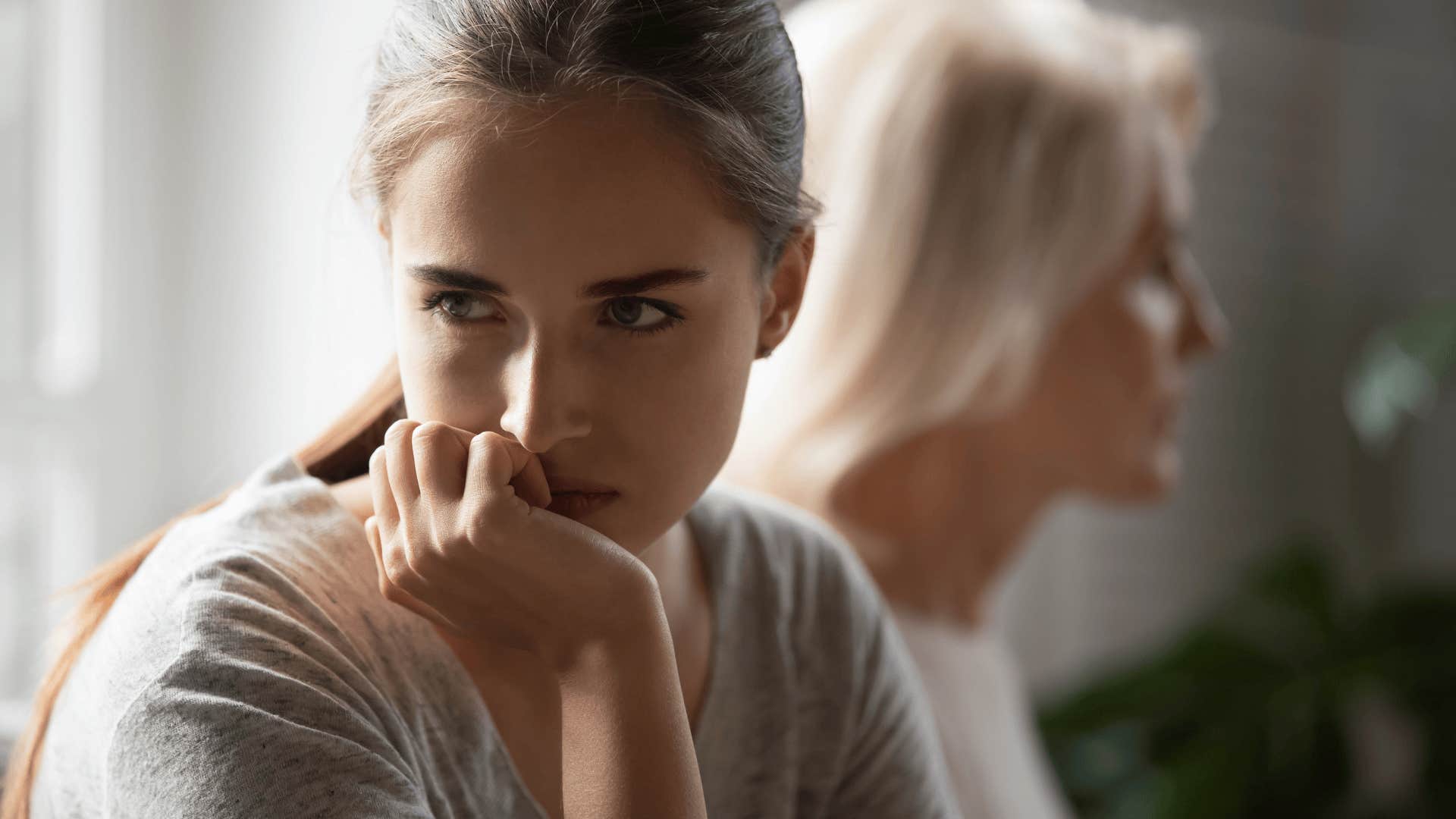 upset adult woman turned away from her mom