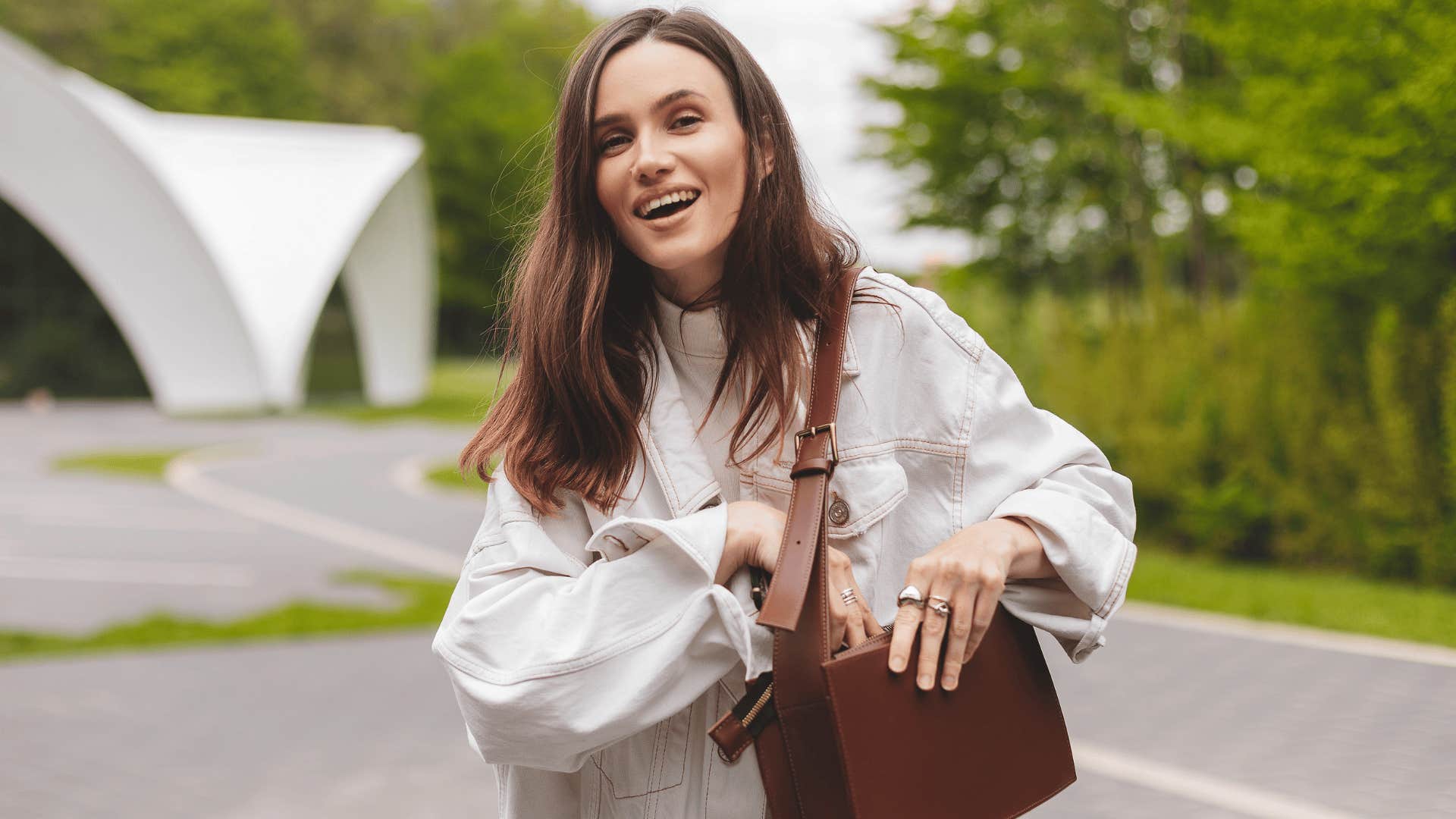 smiling woman reaching into her purse
