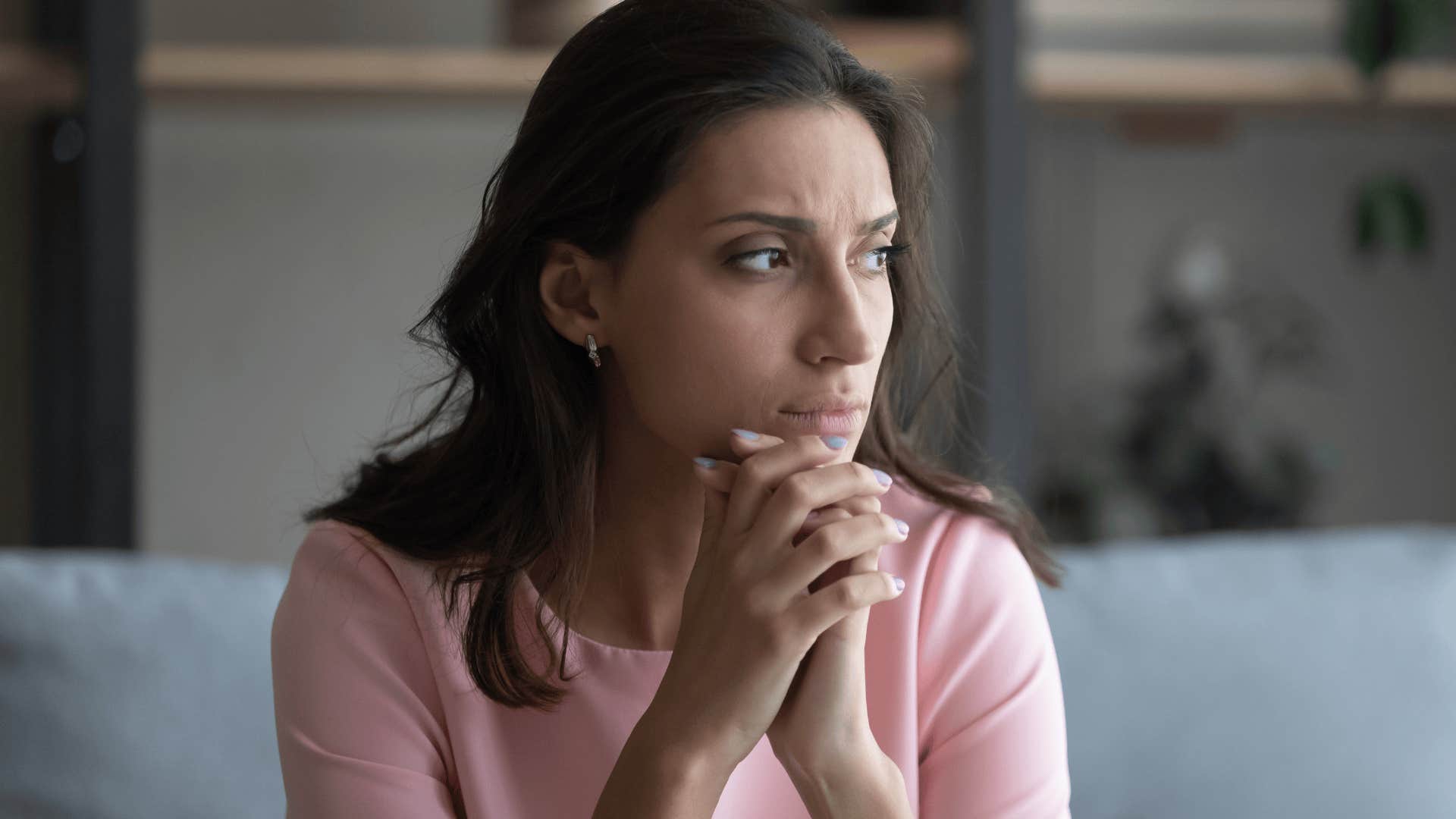 woman looking upset with head in her hands