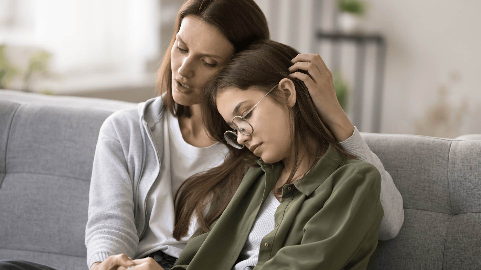 woman comforting her sad younger sister