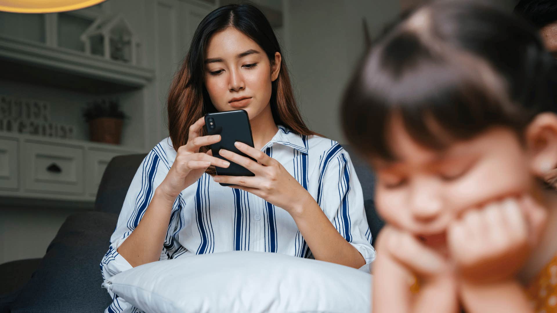 mother on phone ignoring daughter