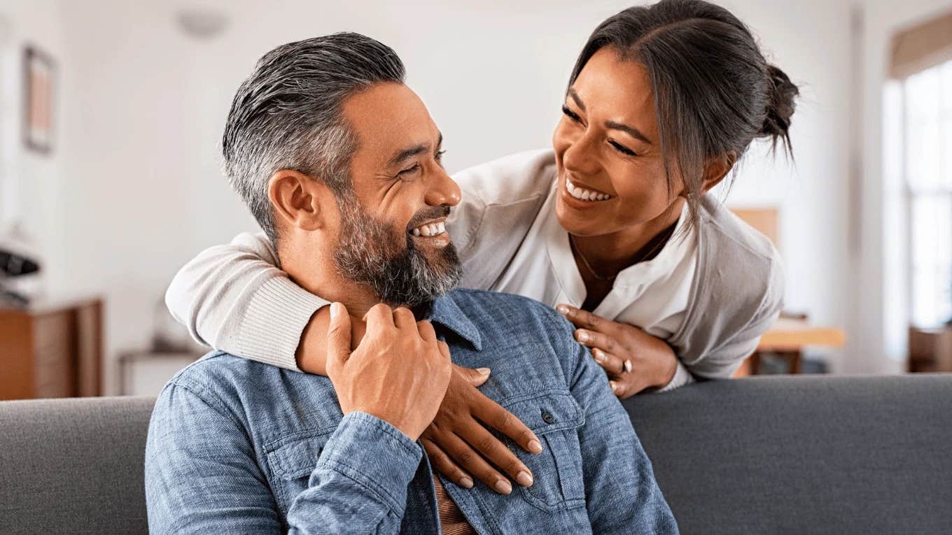 smiling couple looking at each other happily
