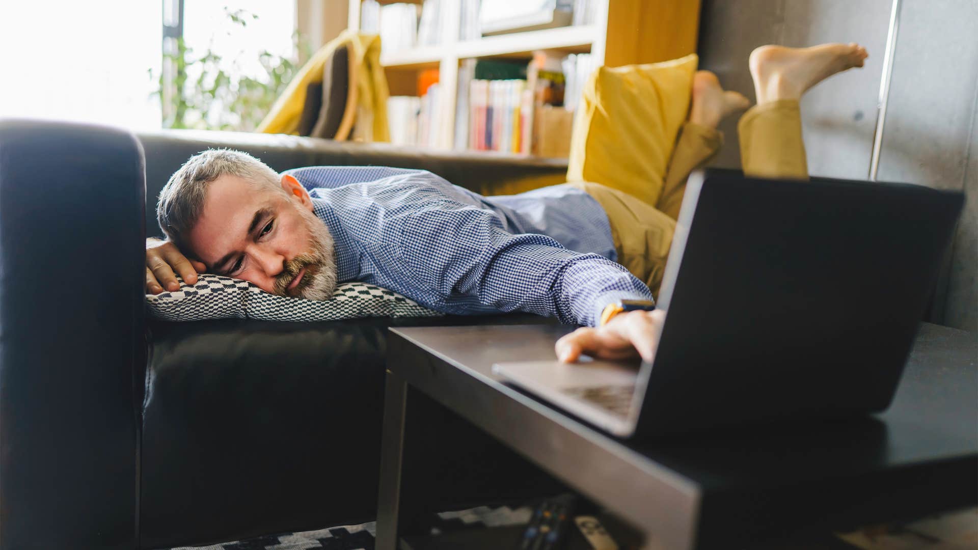 man is less productive than usual because he's emotionally exhausted but pretending to be ok