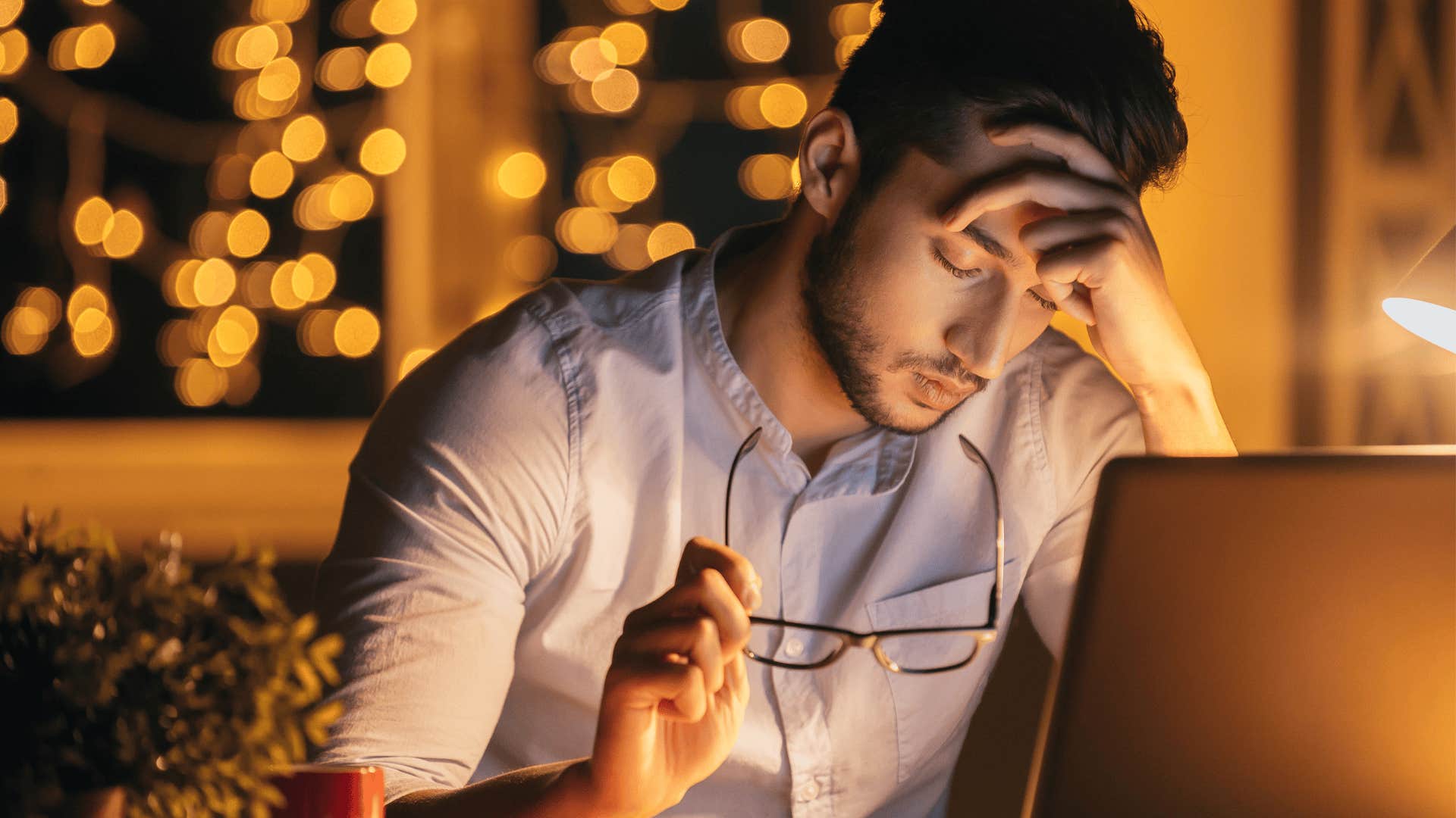 stressed man working late into the night