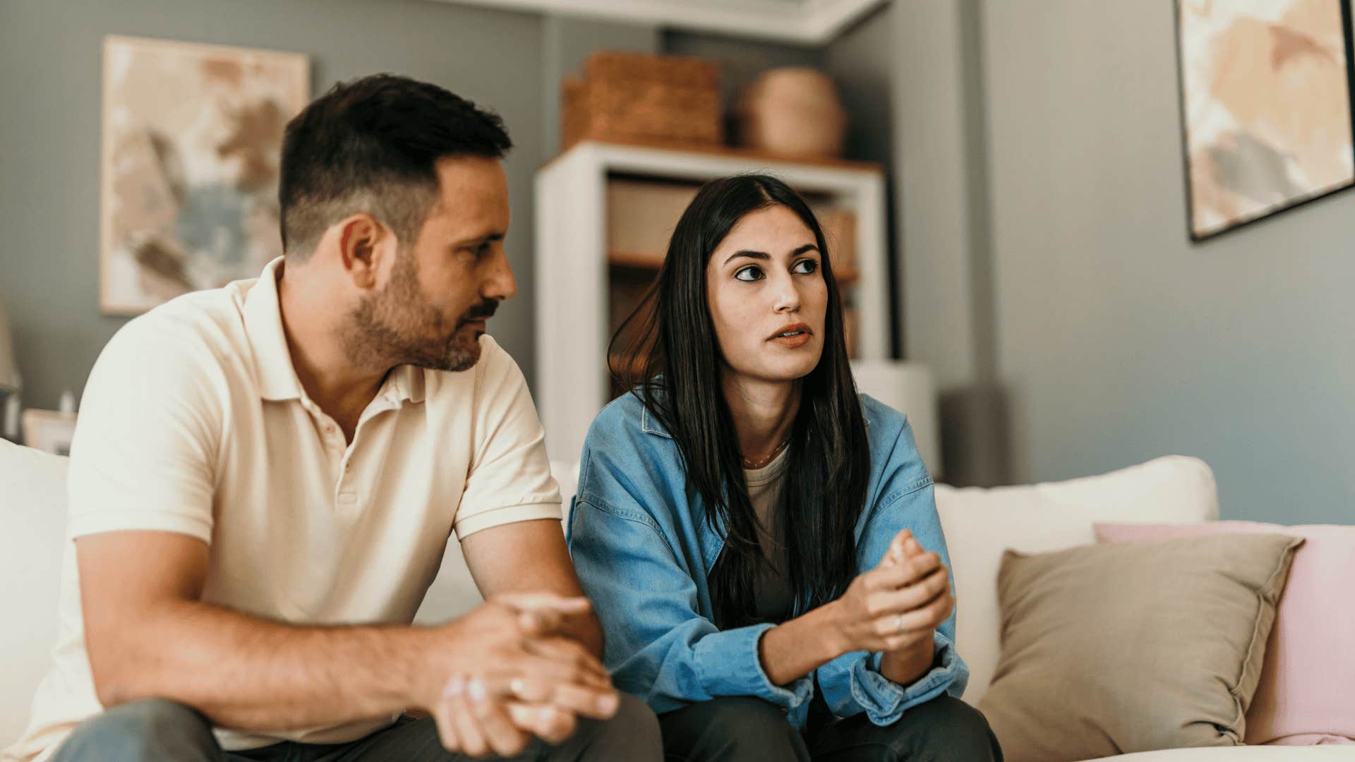 distant couple sitting on couch together 