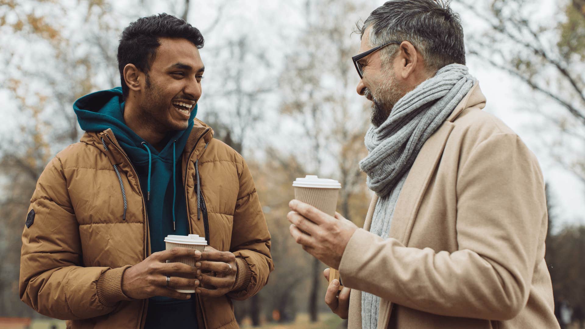 two men smiling and talking over coffee