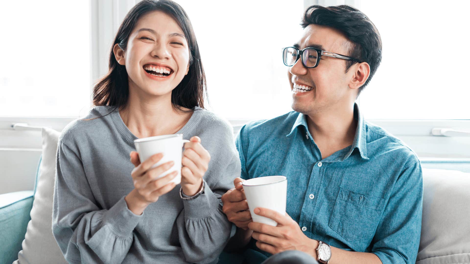 couple smiling and drinking coffee together