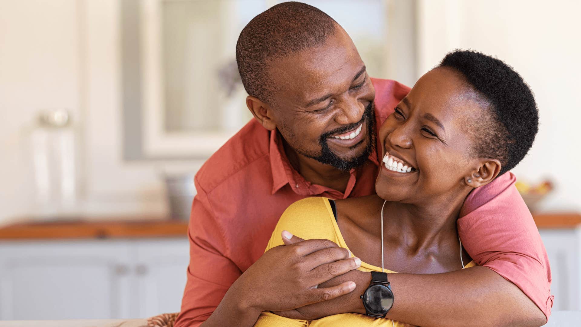 man smiling and hugging his wife