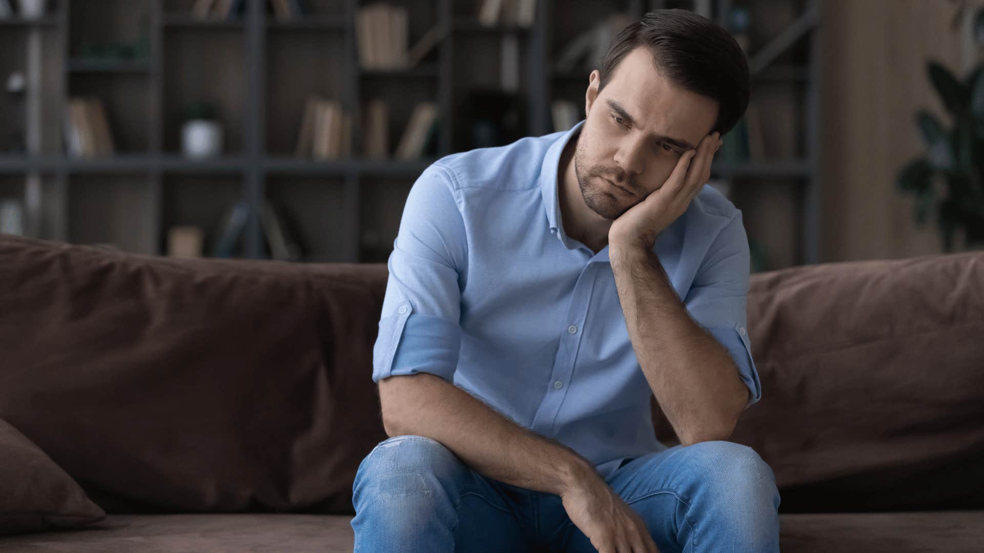 upset man sitting on couch