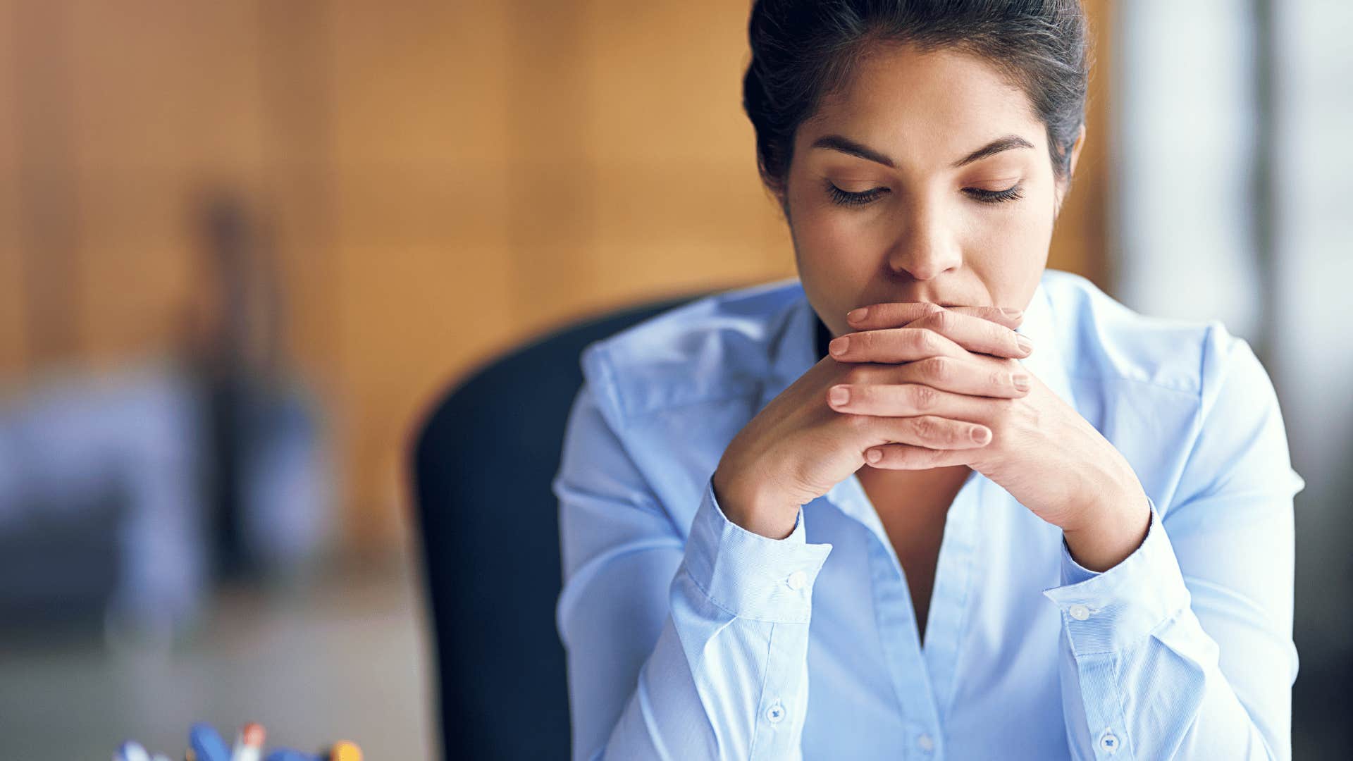 upset woman sitting at desk