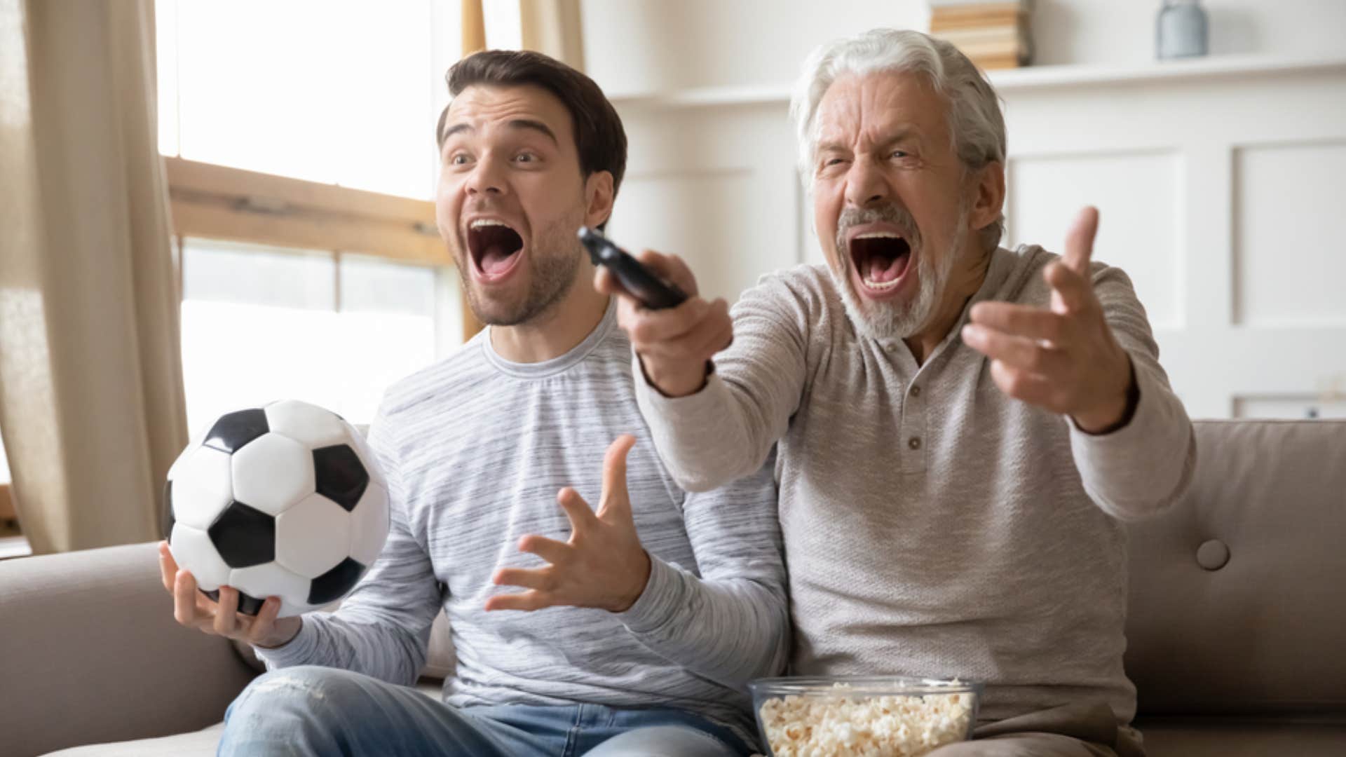 man and boomer dad watching sports together