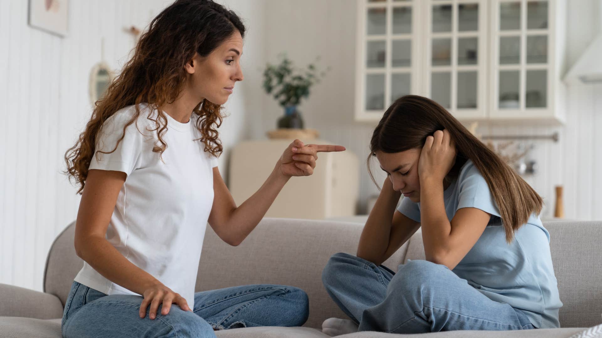 mother punishing and yelling at daughter
