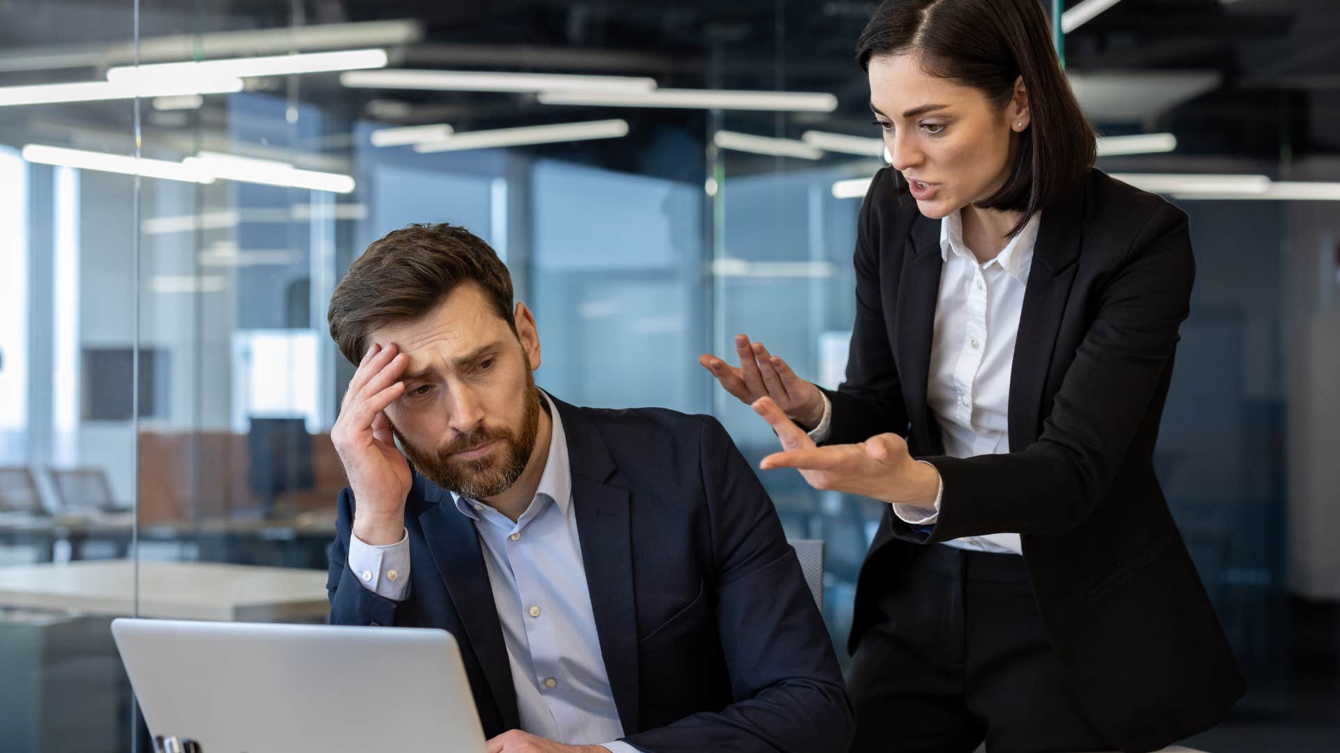 boss talking down to annoyed worker