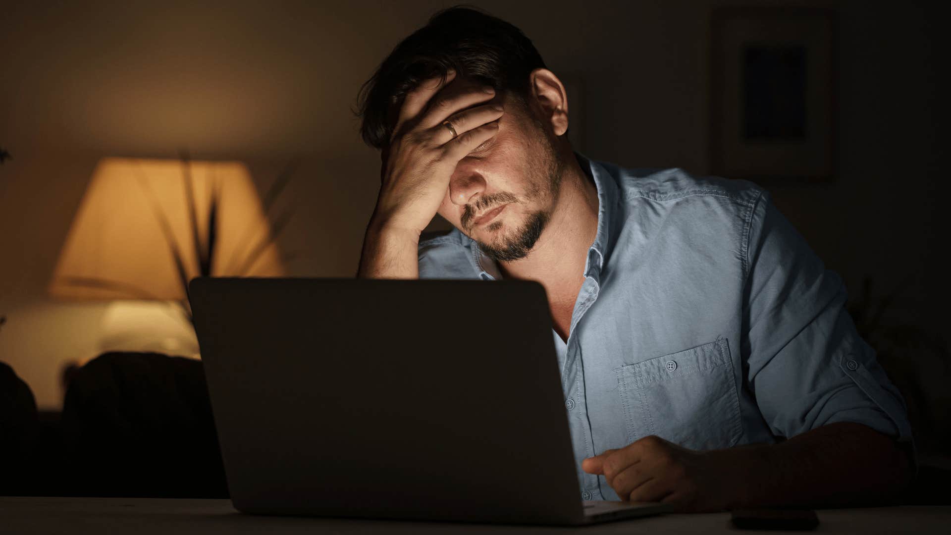 anxious man working in the dark