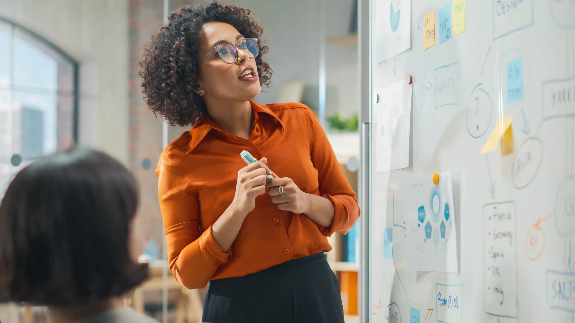 underpaid woman with whiteboard in work meeting