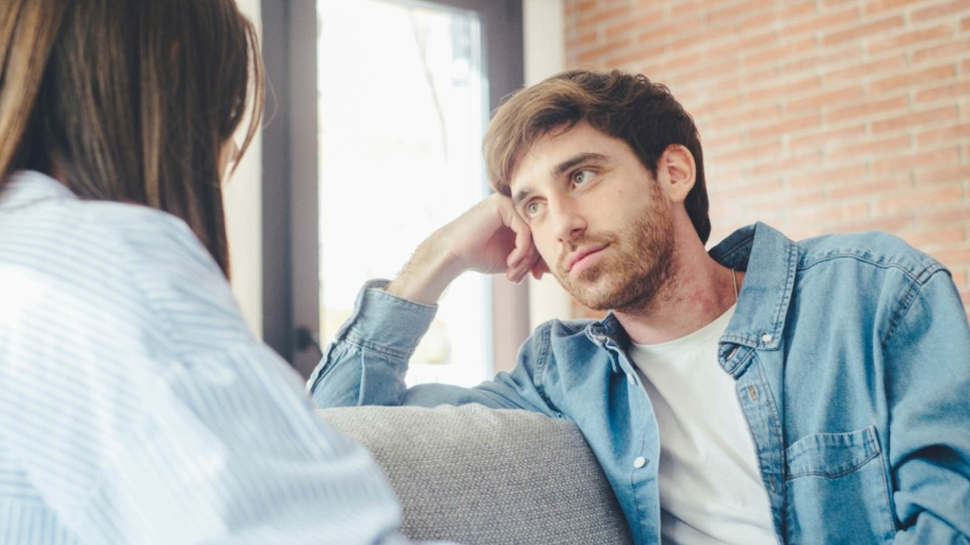 man listening intently to woman speak