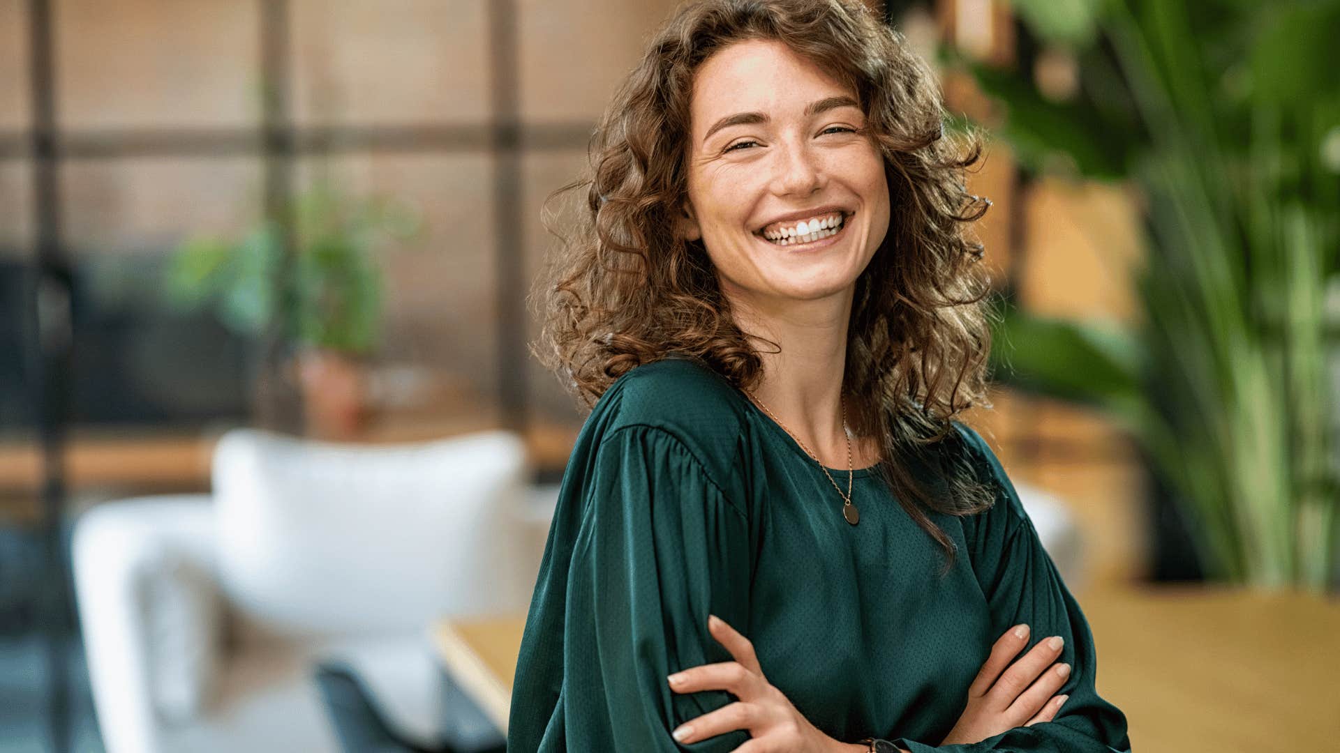 smiling woman with her arms crossed