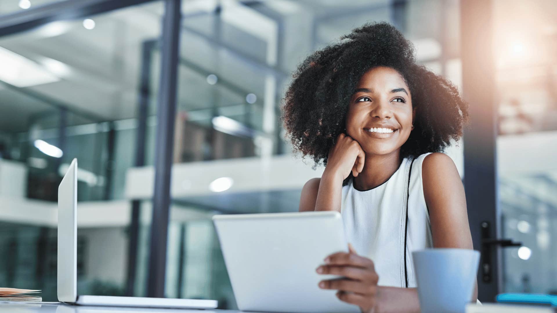 woman smiling while on laptop