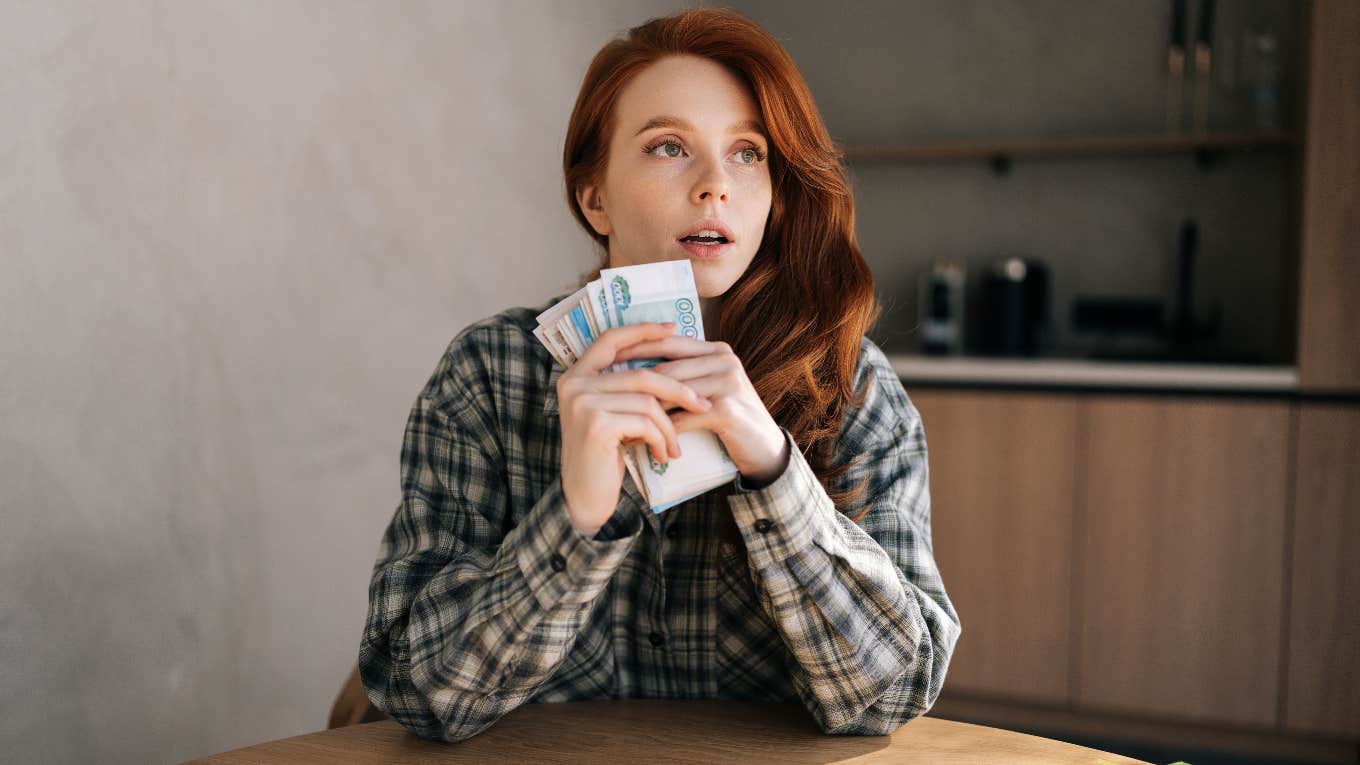 Woman holding the money her brother gifted her
