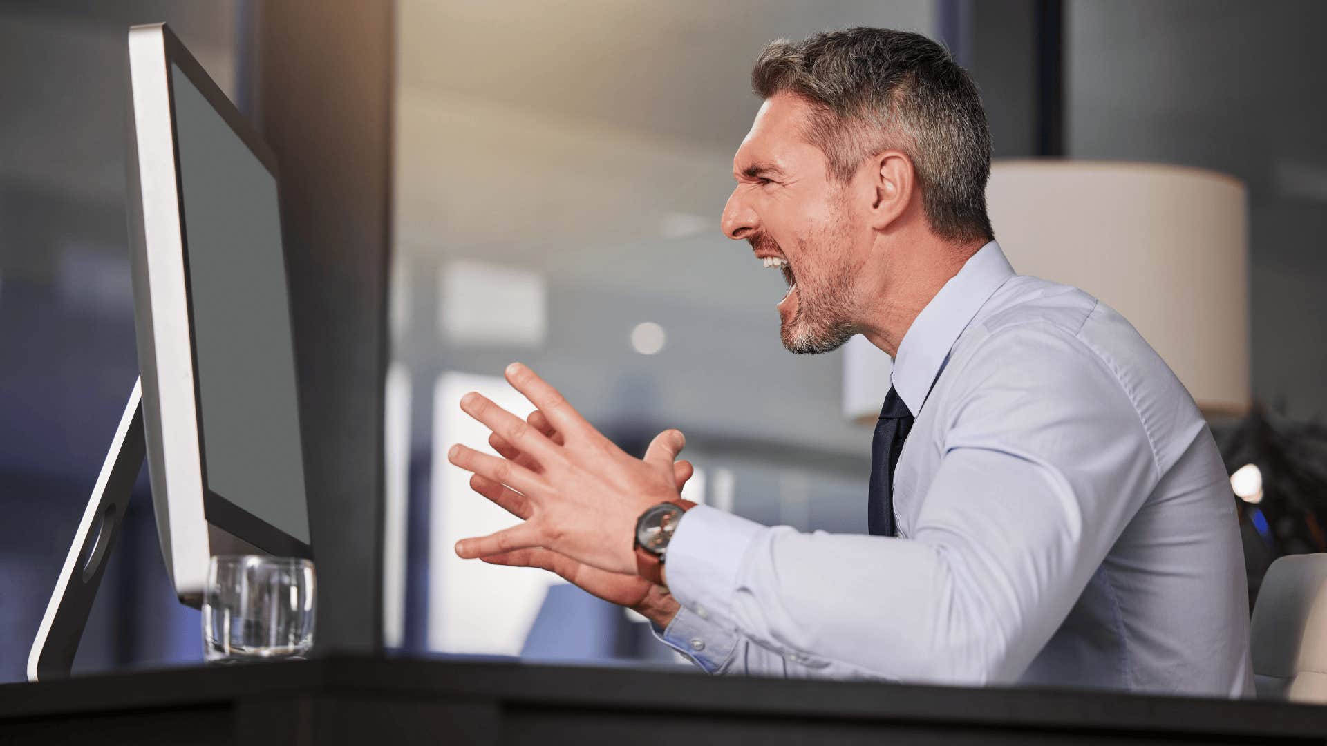 man yelling at computer that makes him look way less experienced