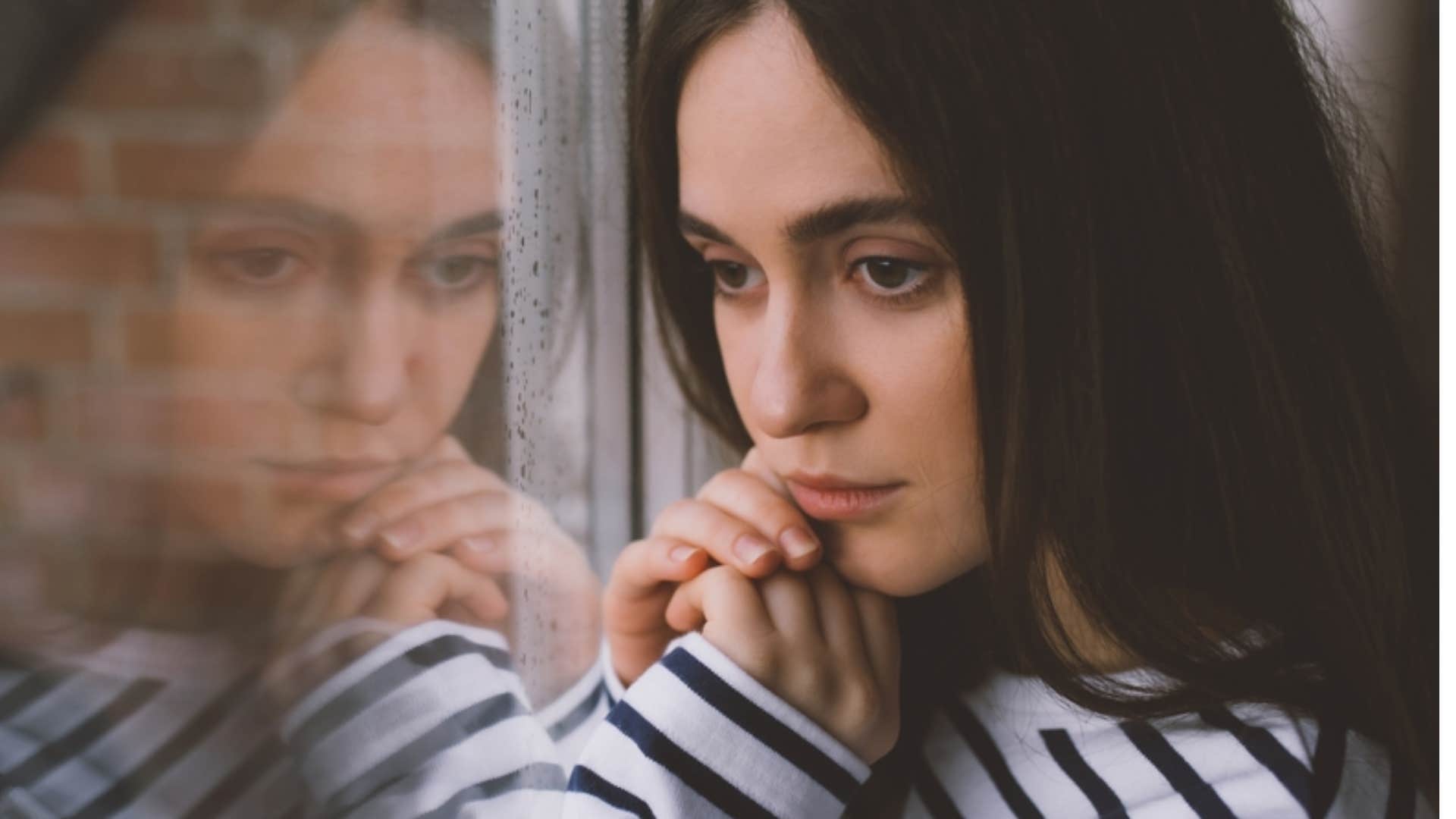 unhappy woman looking out the window