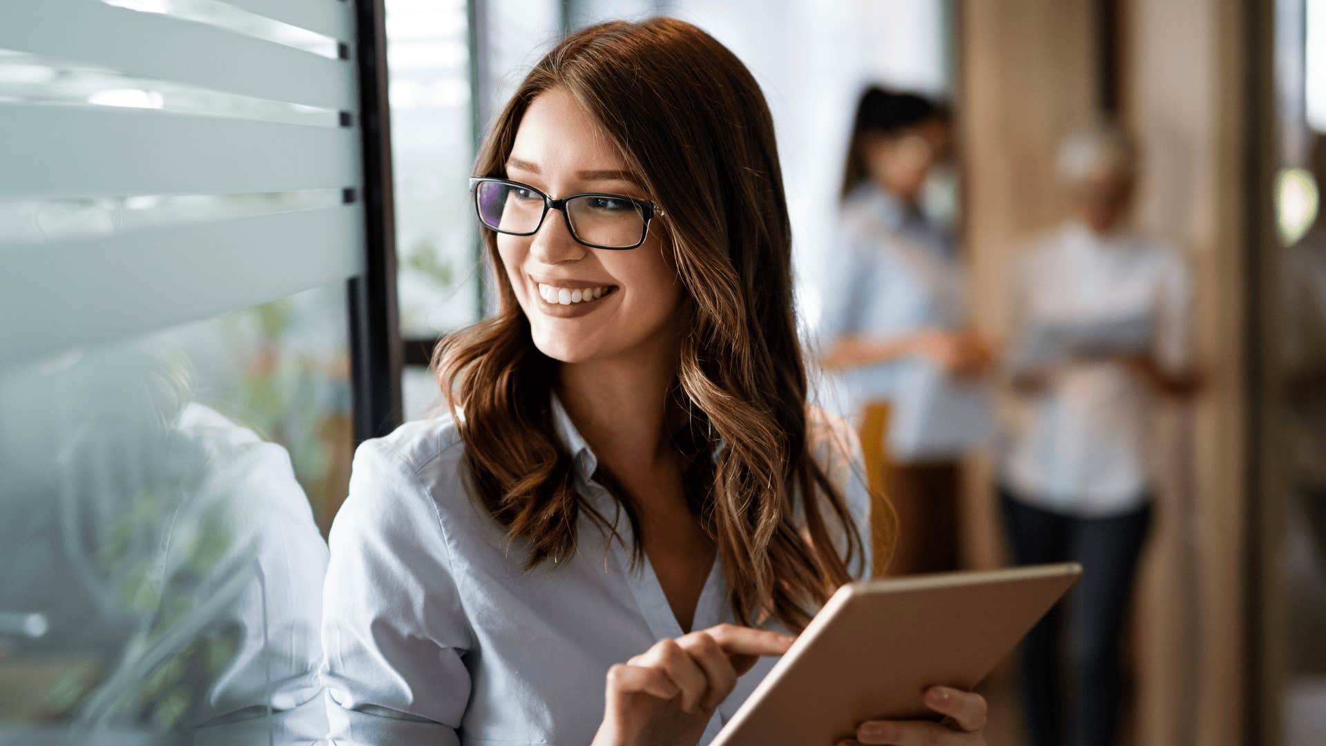 woman smiling with tablet