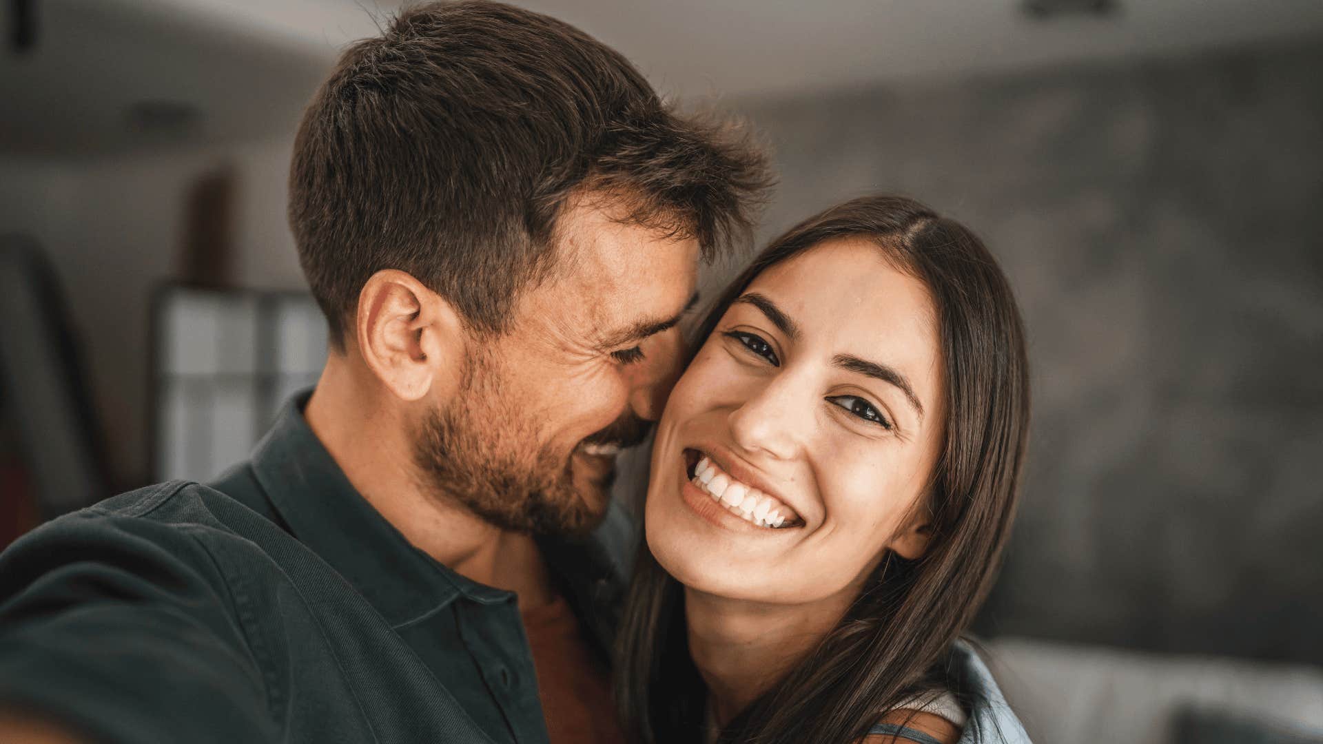 couple smiling and hugging