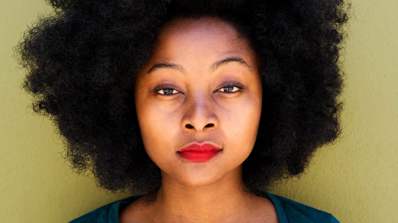 Identify What's Keeping You From Life Of Dreams Woman with natural Black hair looks into camera, wondering what keeps her from life of her dreams