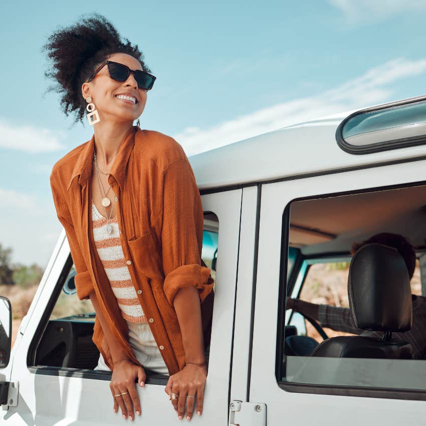 woman who was born to win leaning out of car window