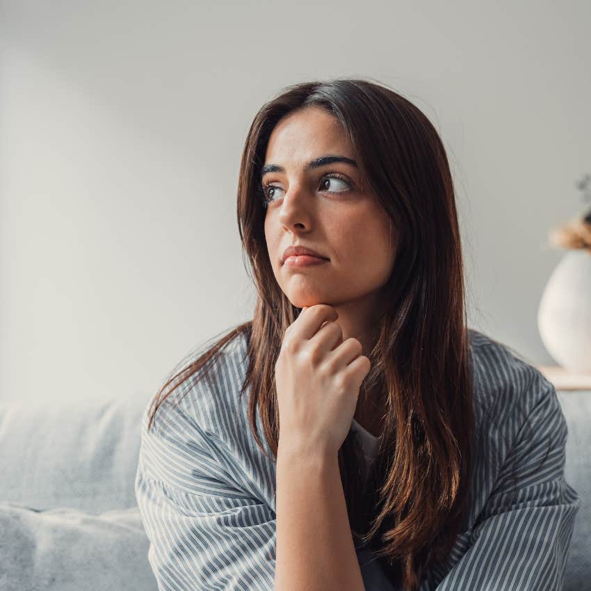 woman with childhood trauma sitting in chair thinking
