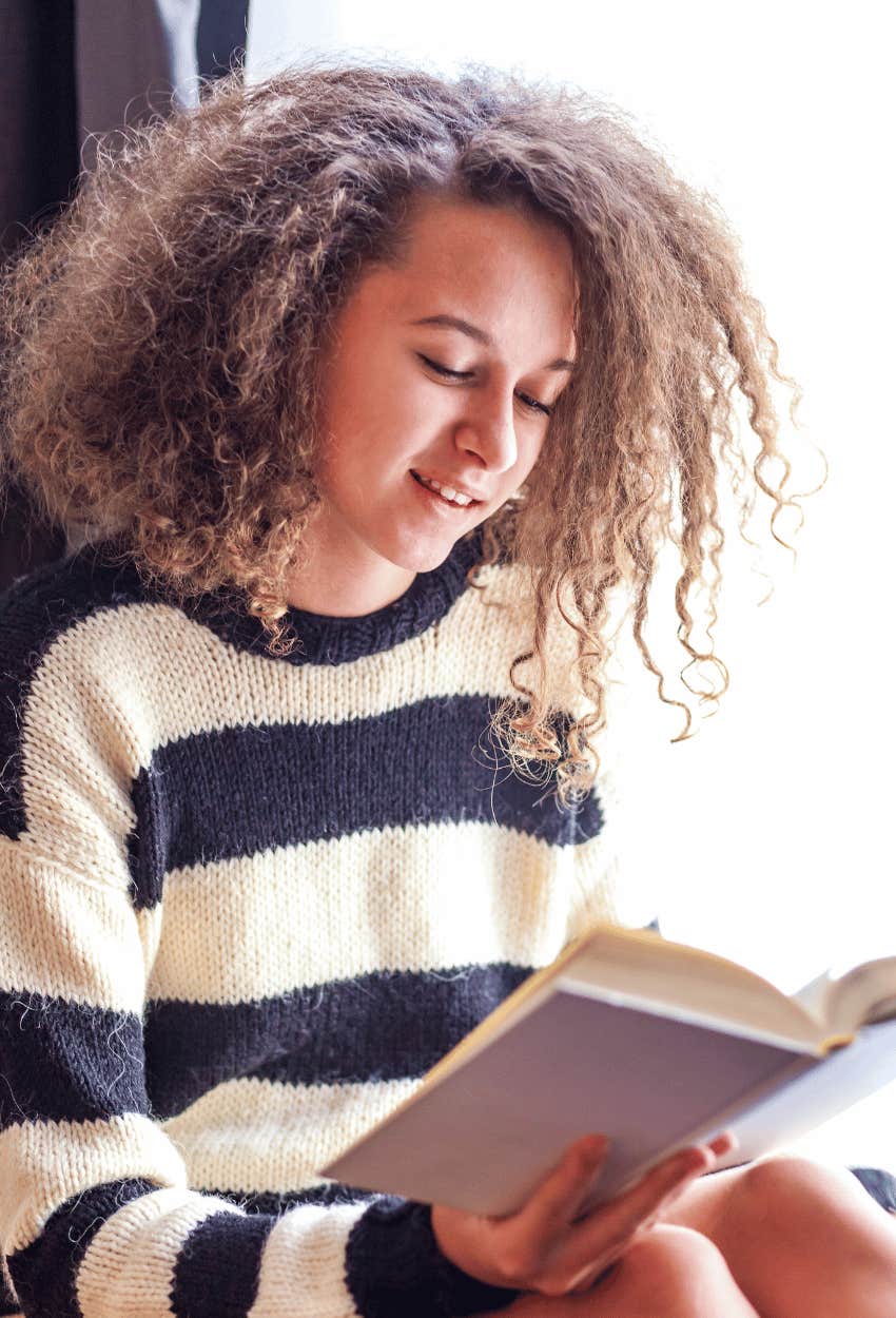 Teen student trying to improve reading skills after teacher told her reading level