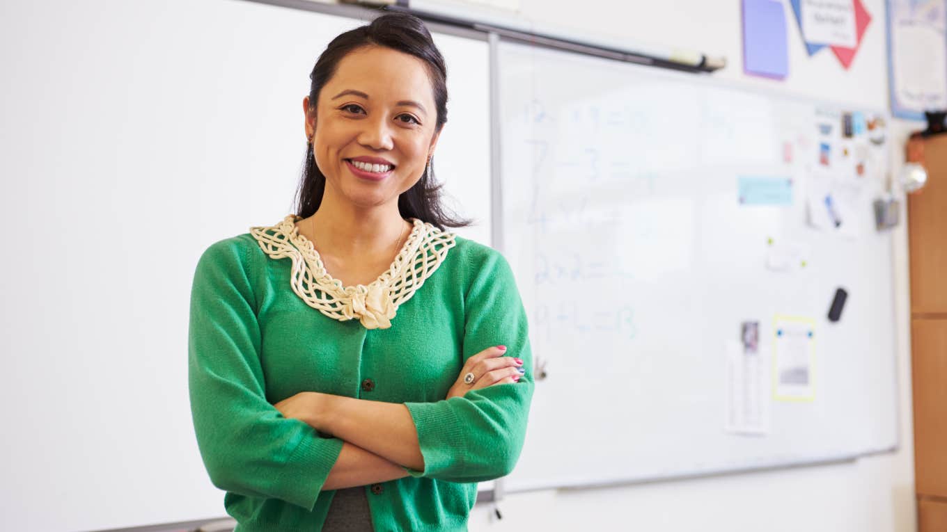 Teacher Shares List Of Gift Options She's Eligible For After 10 Years Of Working At The School District teacher standing in front of white board in classroom