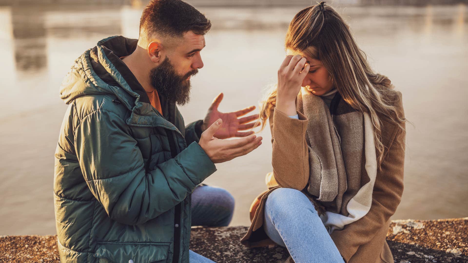 upset couple sitting by the water is a huge red flag