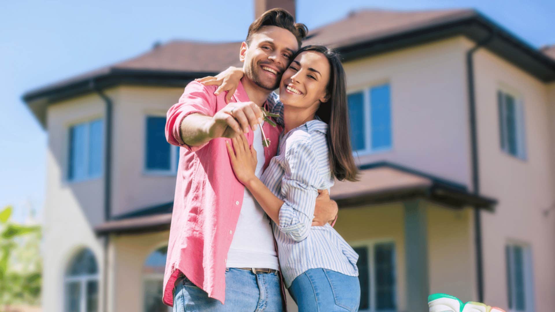 couple standing in front of new home