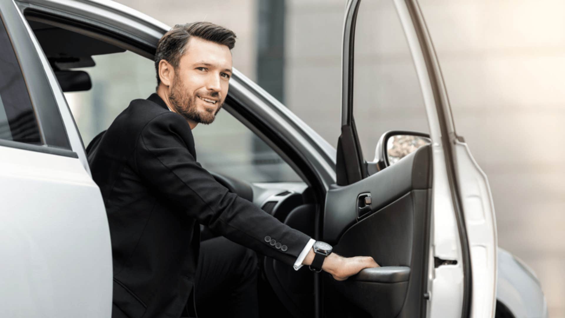 man getting out of expensive car