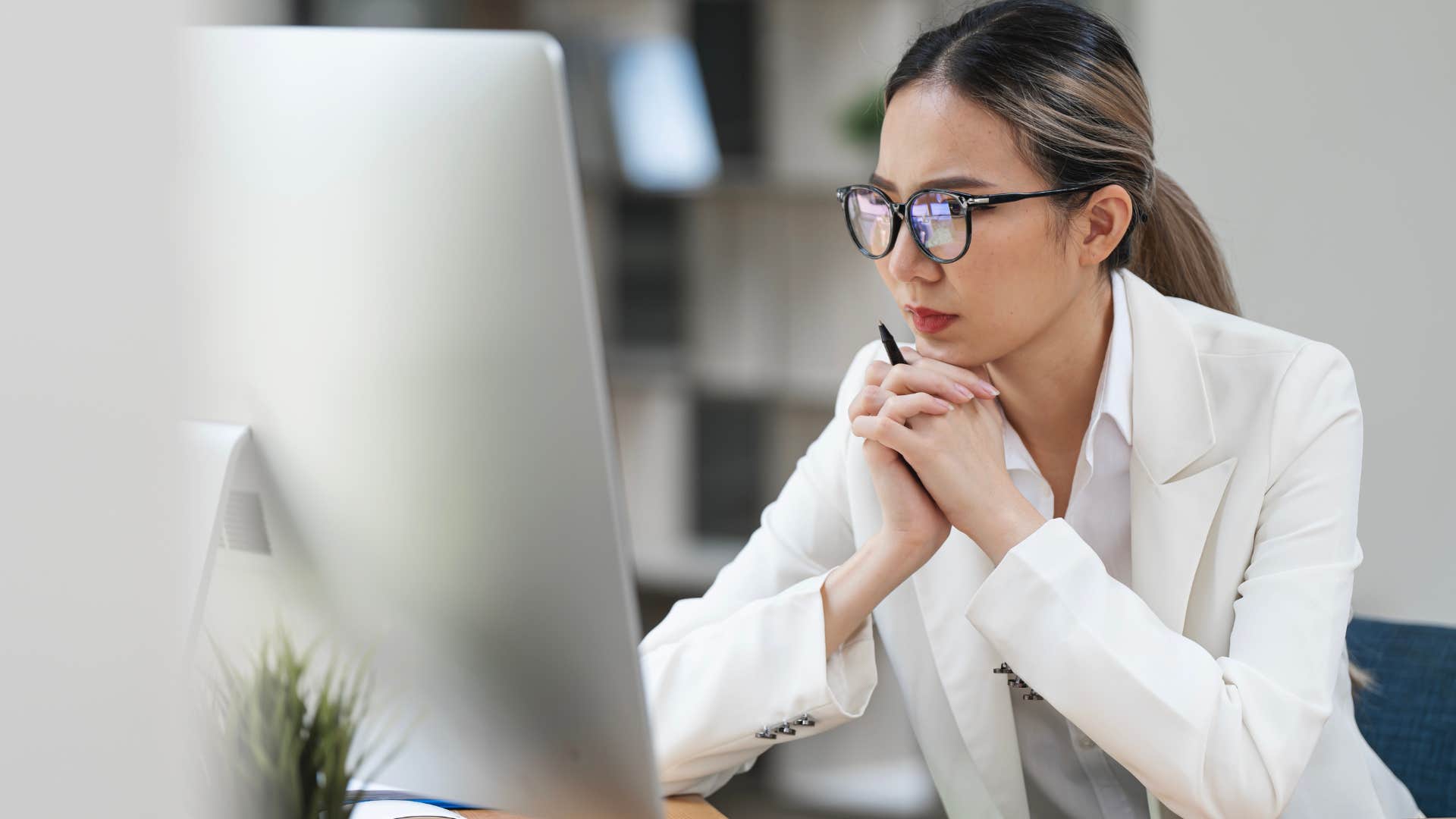 professional Gen Z woman focusing on her laptop