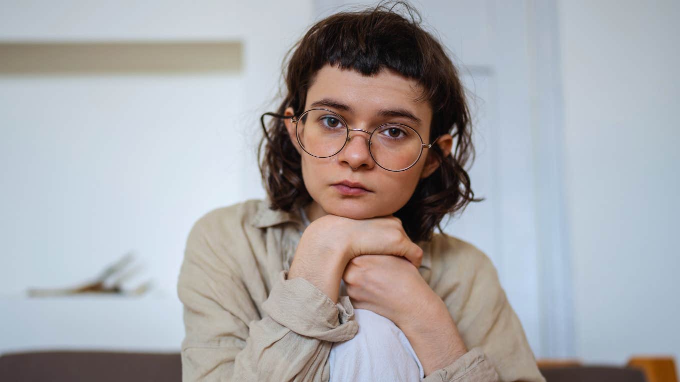 Things Gen Z Secretly Struggles With But Won't Admit sad gen z person with hands on their knee