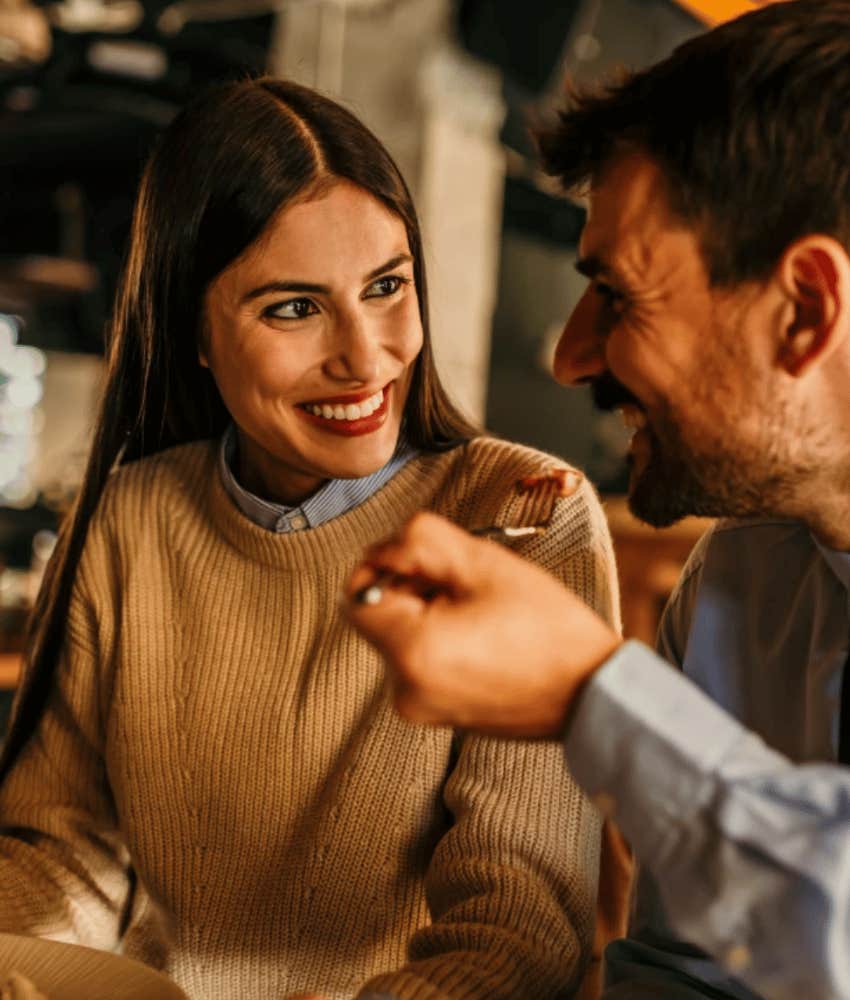 Gen Z woman smiling at man, happy with her dating life