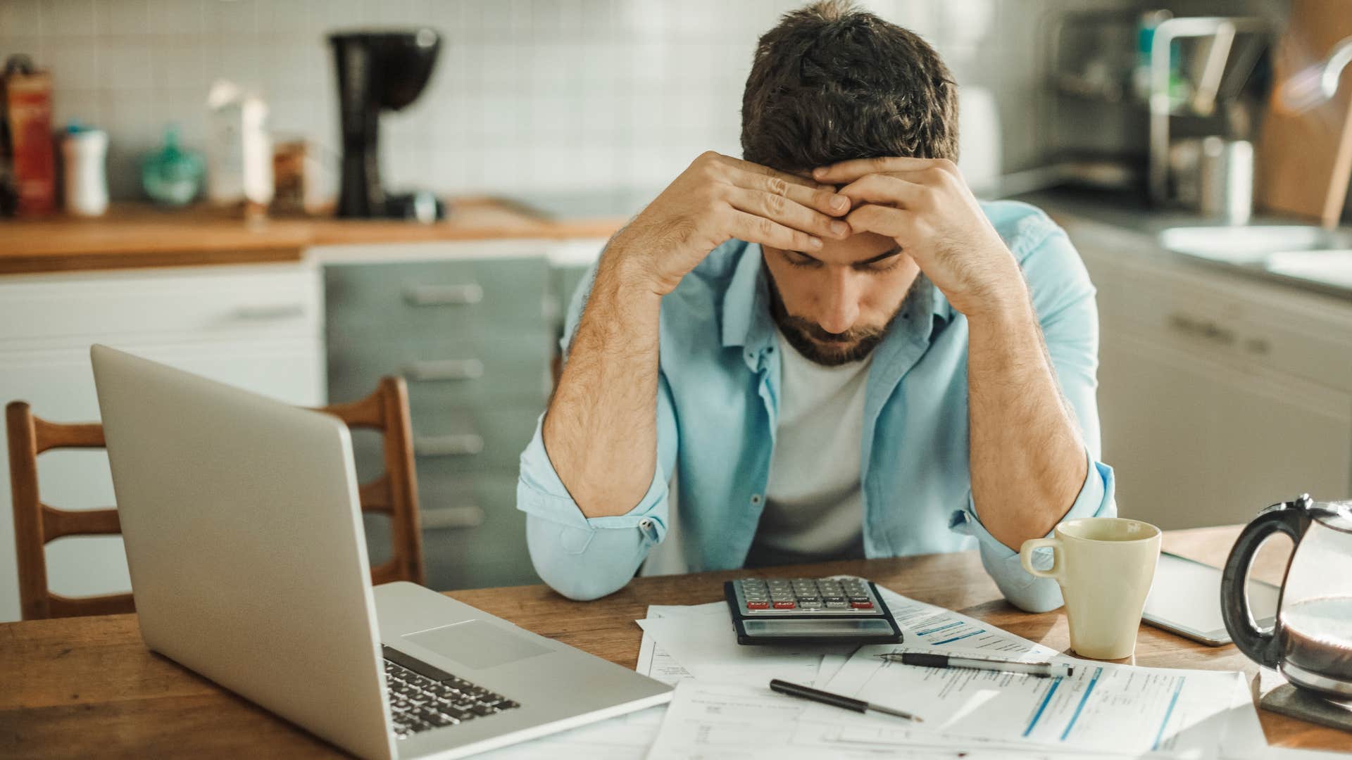 man stressed about paying bills