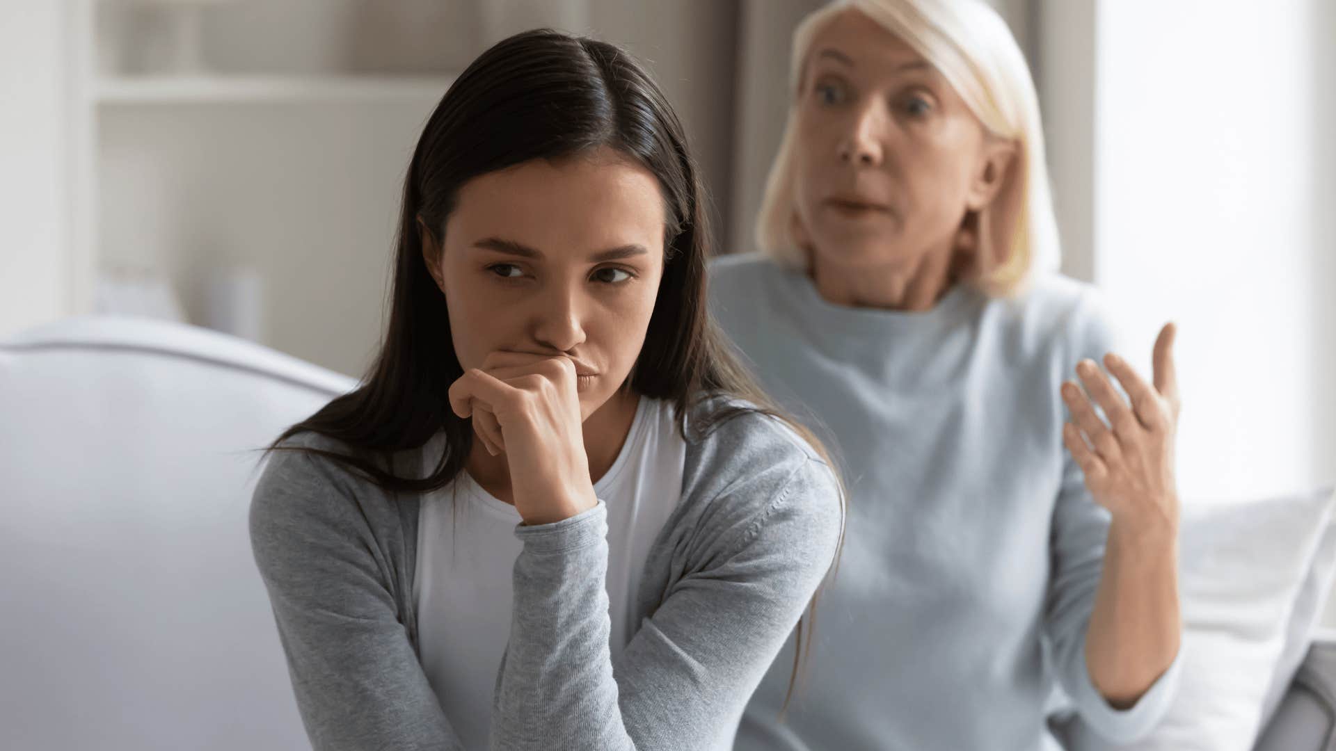 upset Gen Z woman turned away from her mother