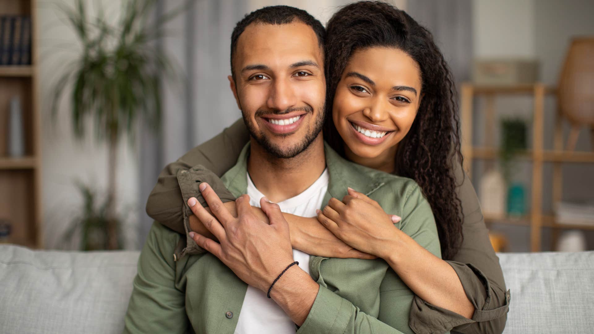 gen z couple smiling happily
