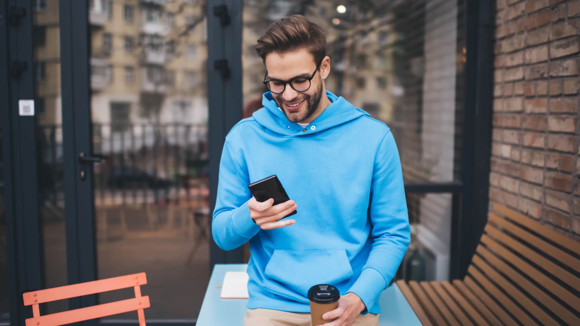 gen z man on his phone holding coffee